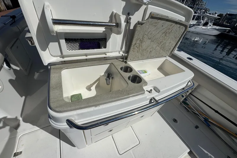  Yacht Photos Pics 2019 Boston Whaler 330 Outrage boat sink and storage area, docked by the water.