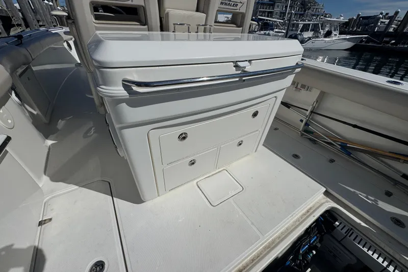  Yacht Photos Pics 2019 Boston Whaler 330 Outrage boat interior with storage compartments and seating.