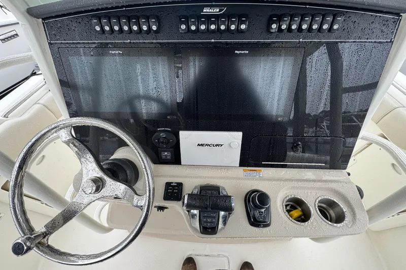  Yacht Photos Pics 2019 Boston Whaler 330 Outrage helm with steering wheel, controls, and electronic displays.