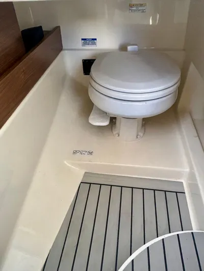  Yacht Photos Pics 2020 Boston Whaler 280 Vantage boat interior with toilet and wood accents.