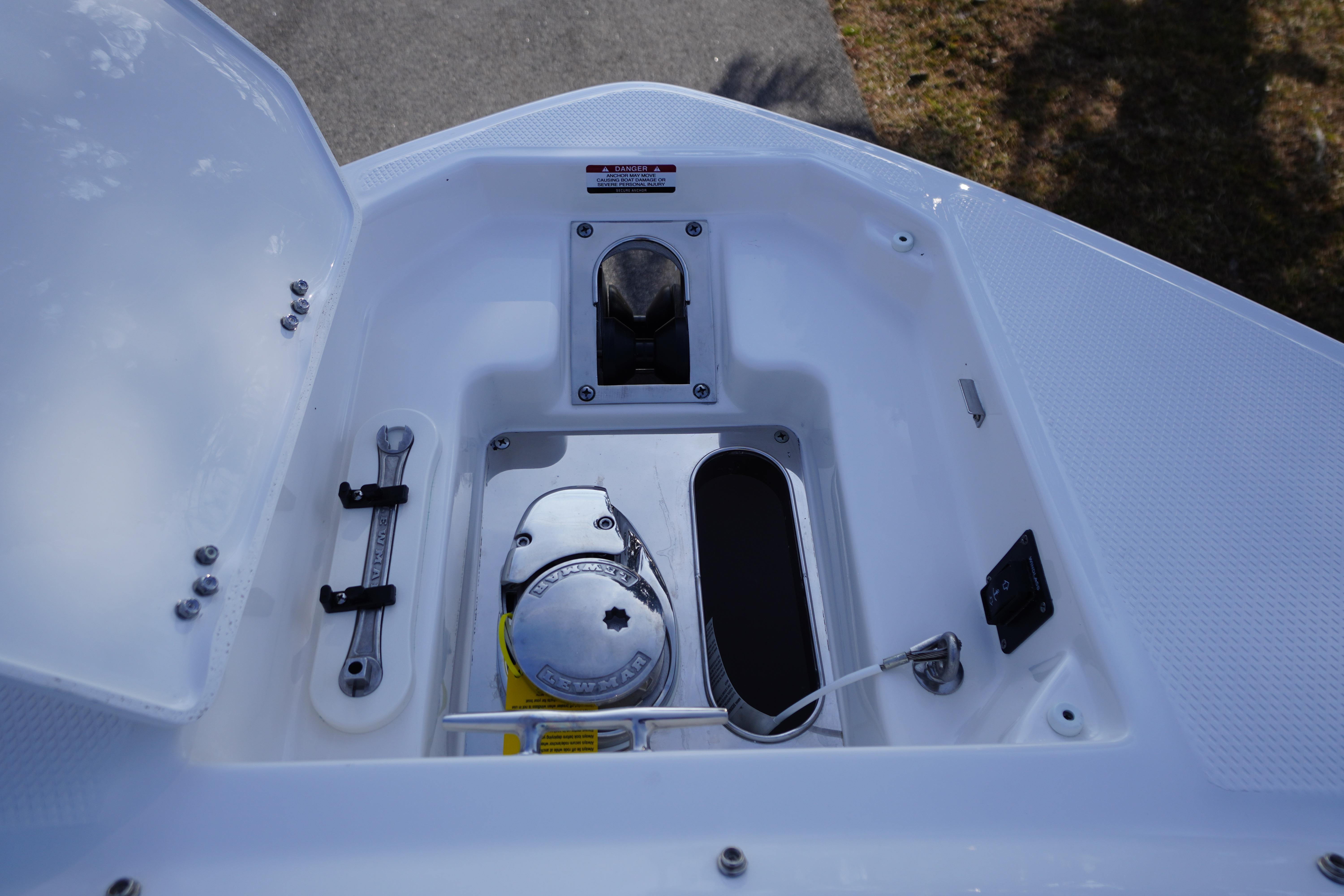 2026 Chaparral 280 OSX boat anchor compartment with tools and equipment.