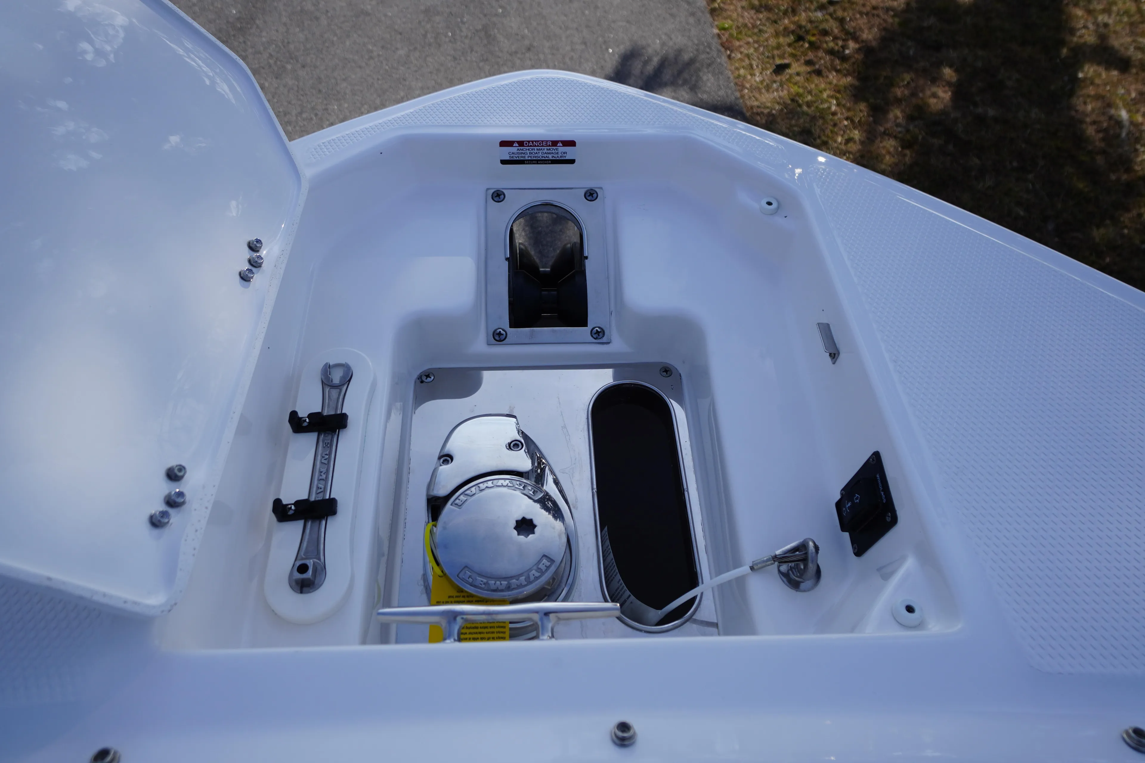 2026 Chaparral 280 OSX boat anchor compartment with tools and equipment.