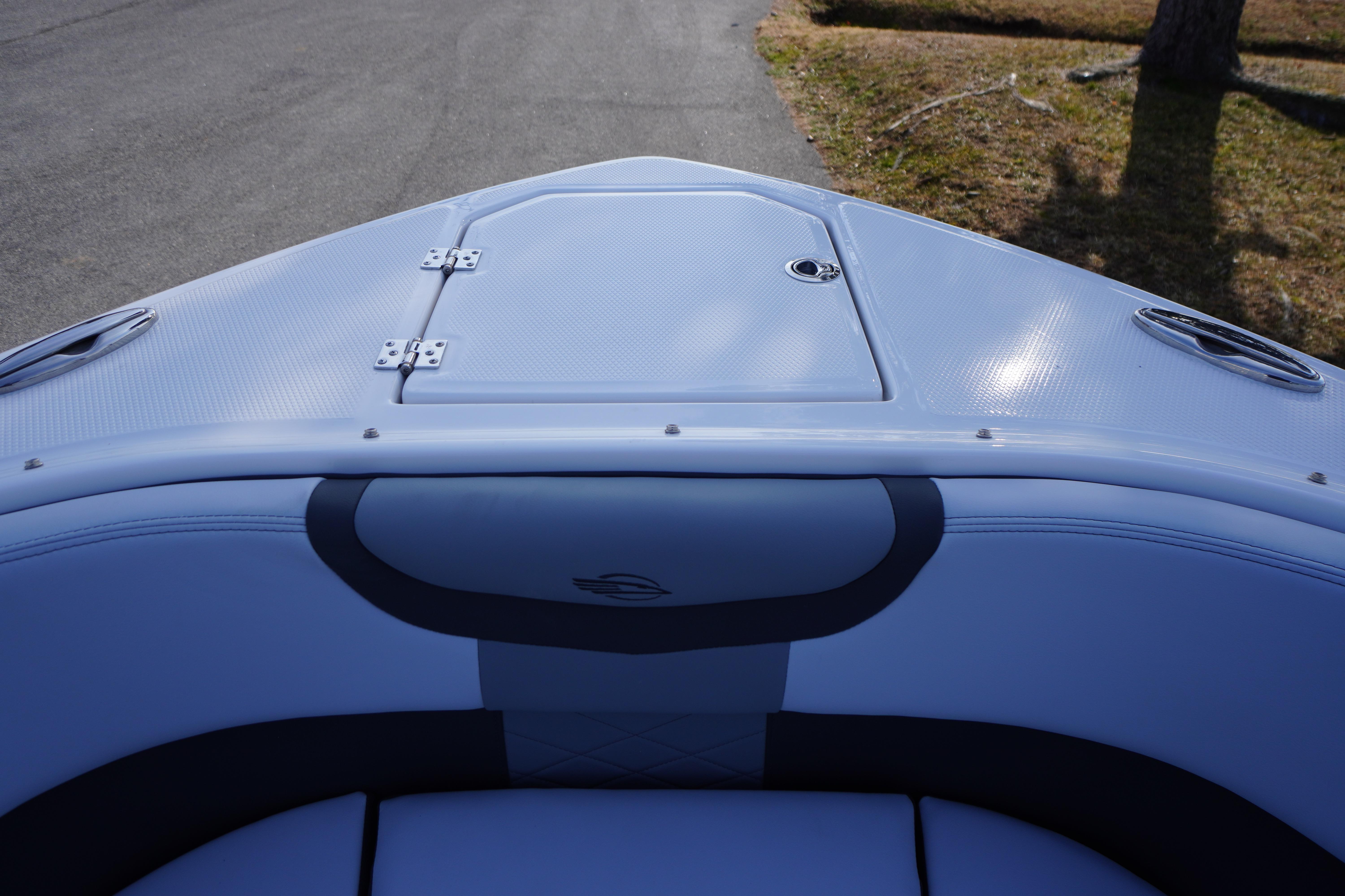 Bow view of 2026 Chaparral 280 OSX boat with sleek design and storage hatch.