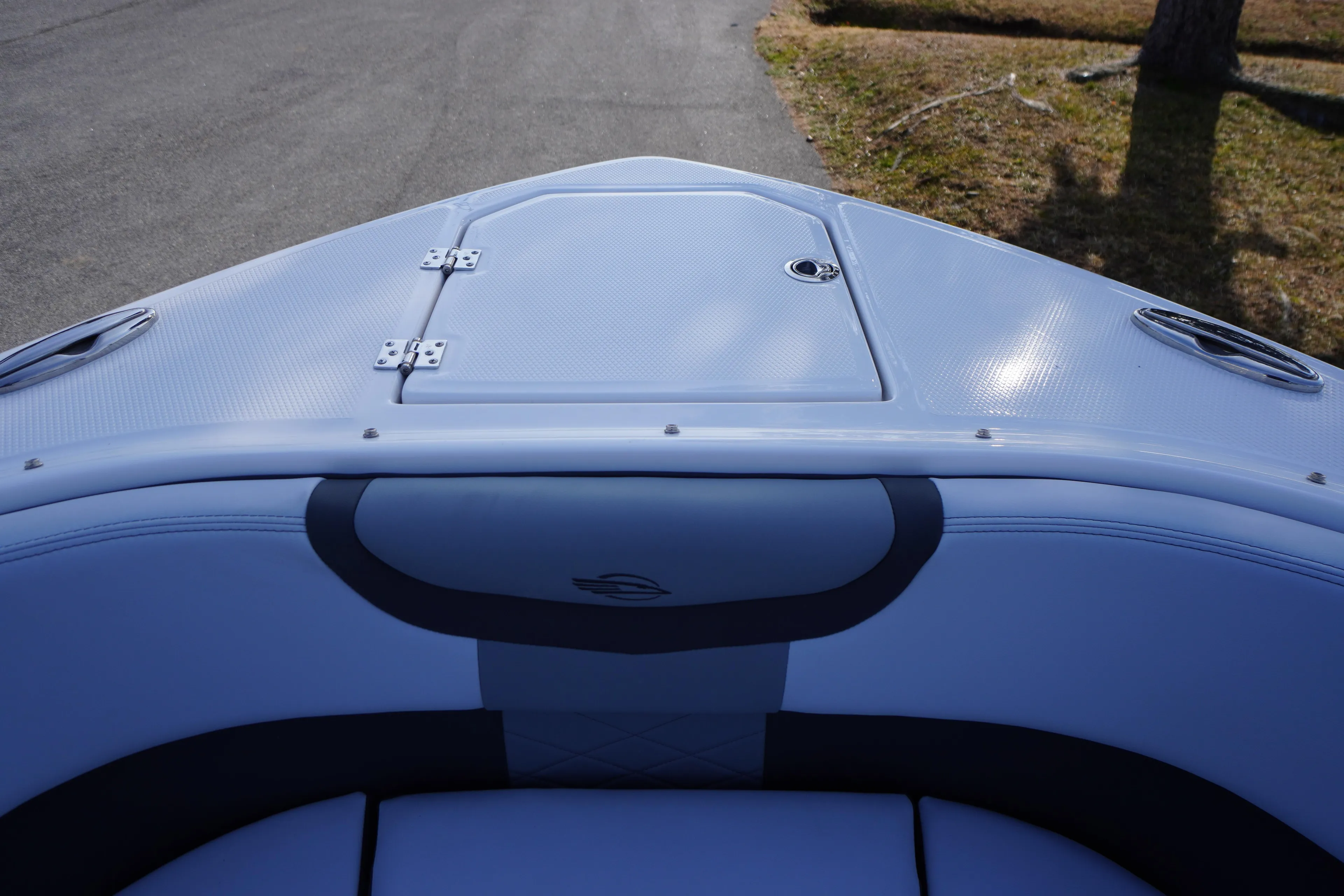 Bow view of 2026 Chaparral 280 OSX boat with sleek design and storage hatch.