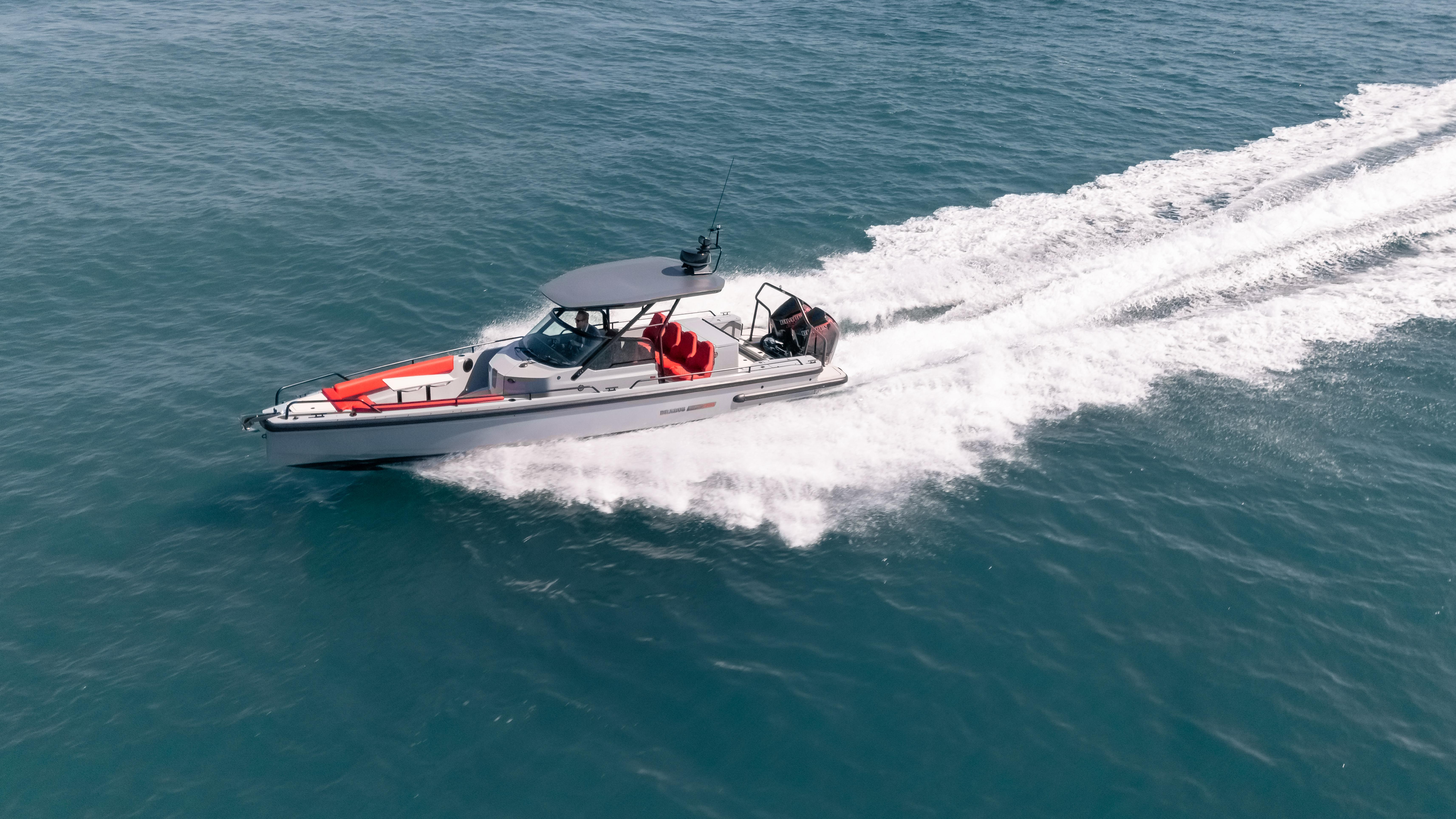 2023 BRABUS Shadow 500 T-Top boat cruising on open water.