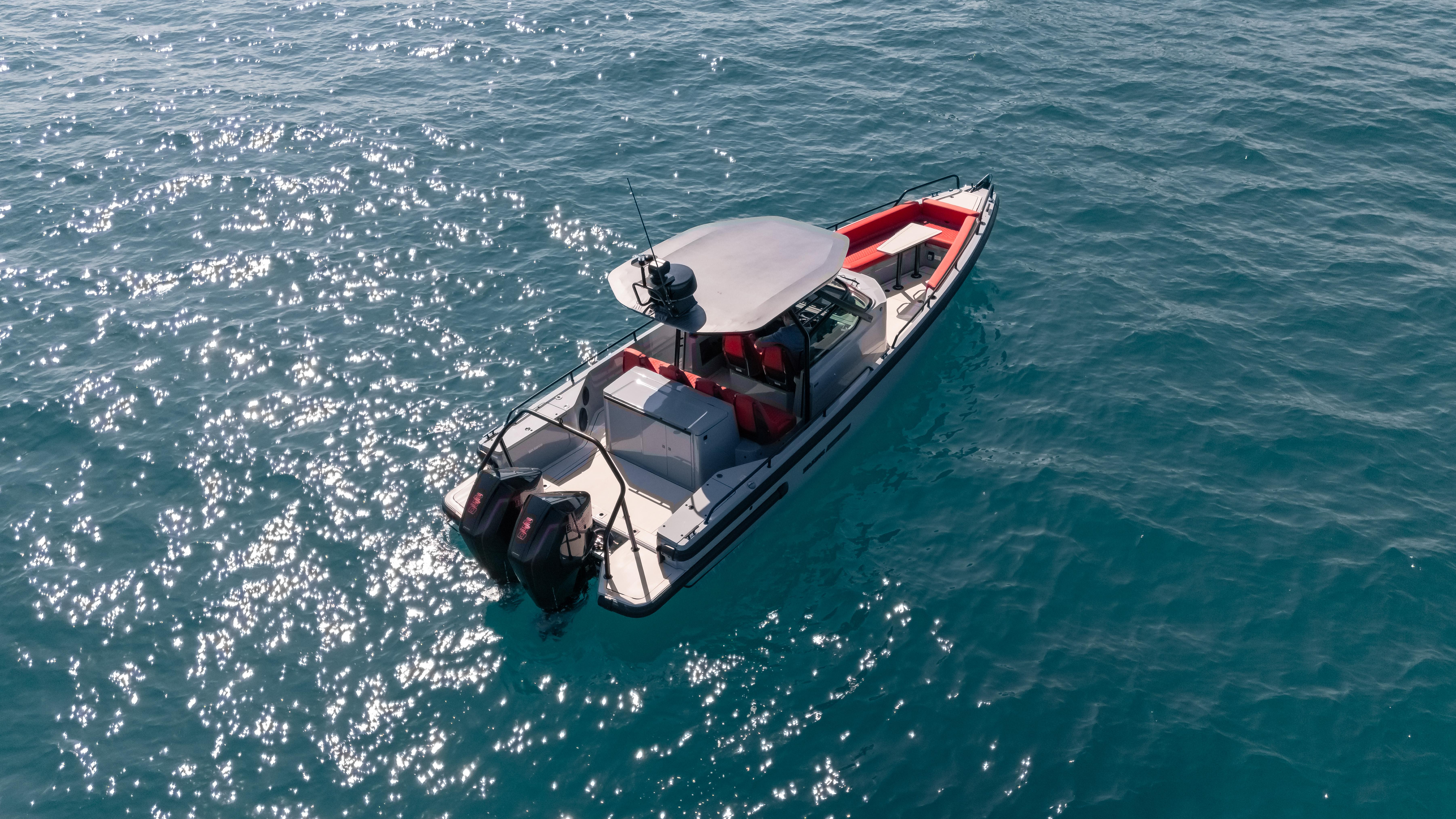 2023 BRABUS Shadow 500 T-Top boat cruising on clear blue water.