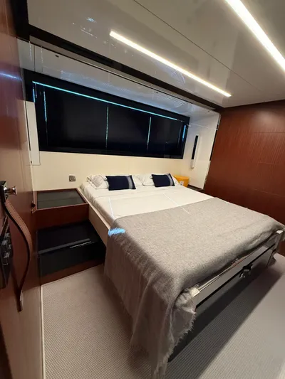 4946 Yacht Photos Pics Luxurious bedroom interior of 2023 Riva 56 Rivale yacht with modern design and cozy bedding.