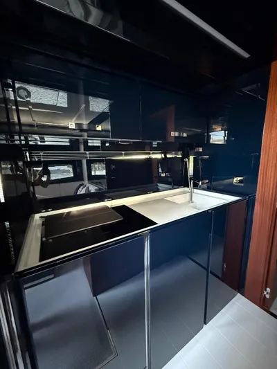 4946 Yacht Photos Pics Luxurious kitchen interior of 2023 Riva 56 Rivale yacht, featuring sleek modern design.