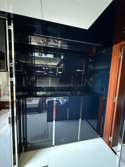 4946 Yacht Photos Pics Luxurious interior of 2023 Riva 56 Rivale yacht with sleek black cabinetry.