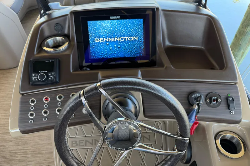  Yacht Photos Pics 2024 Bennington 25 QX Swingback dashboard with steering wheel and digital display.