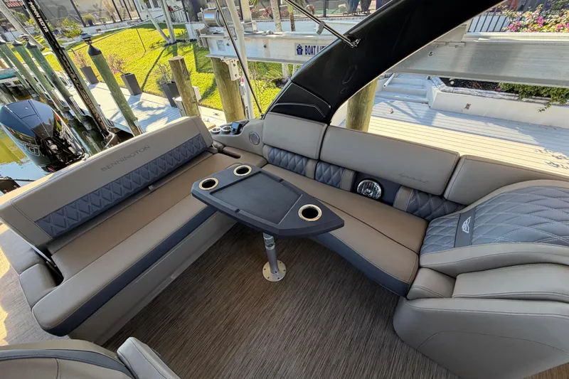  Yacht Photos Pics Luxurious interior of 2024 Bennington 25 QX Swingback pontoon boat with plush seating and table.