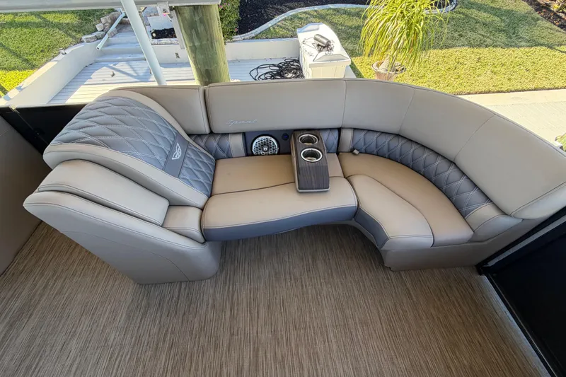  Yacht Photos Pics Luxurious seating on 2024 Bennington 25 QX Swingback boat with cup holders and elegant design.