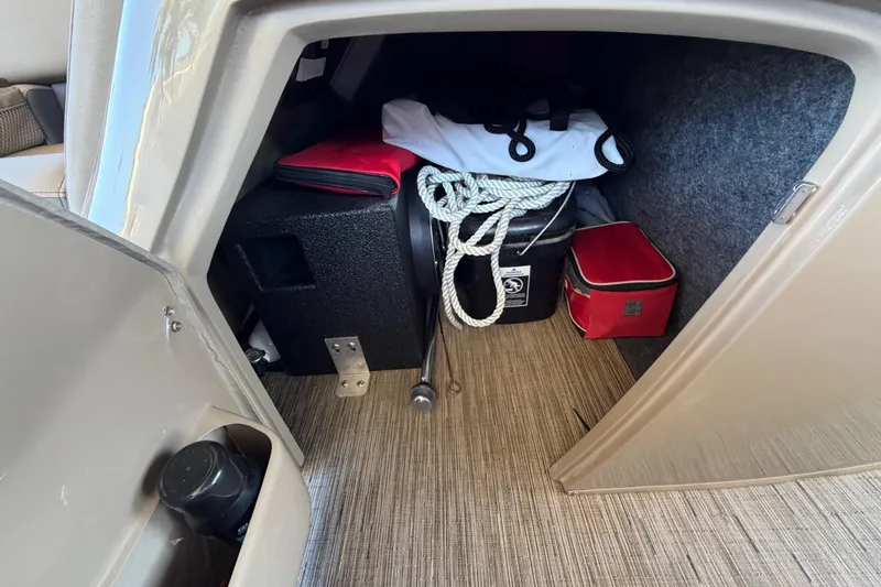  Yacht Photos Pics Storage compartment in 2024 Bennington 25 QX Swingback boat with ropes and equipment.