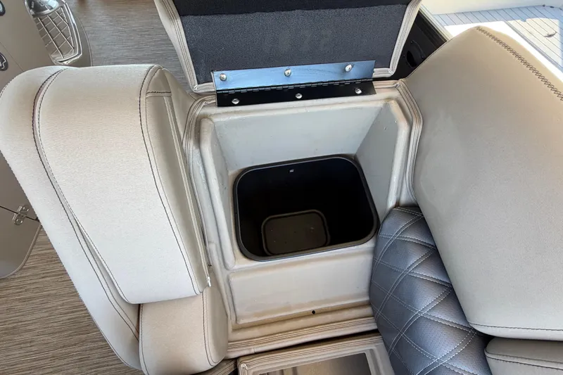  Yacht Photos Pics 2024 Bennington 25 QX Swingback storage compartment with open lid, showcasing interior space.
