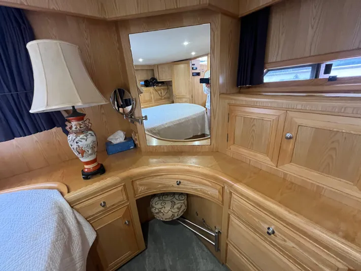Journey Yacht Photos Pics Interior of 1999 Ocean Alexander Sundeck 460 with wooden cabinetry and decorative lamp.