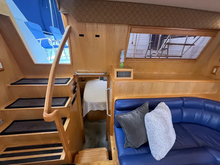 Journey Yacht Photos Pics Interior of 1999 Ocean Alexander Sundeck 460 with blue seating and wooden stairs.