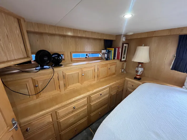 Journey Yacht Photos Pics Cozy cabin interior of 1999 Ocean Alexander Sundeck 460 with wooden cabinetry and soft lighting.