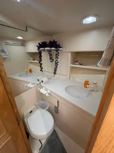 Journey Yacht Photos Pics 1999 Ocean Alexander Sundeck 460 bathroom with dual sinks and modern amenities.