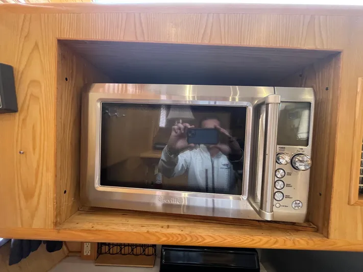 Journey Yacht Photos Pics Built-in microwave in Ocean Alexander Sundeck 460 yacht, 1999 model, wooden cabinetry.