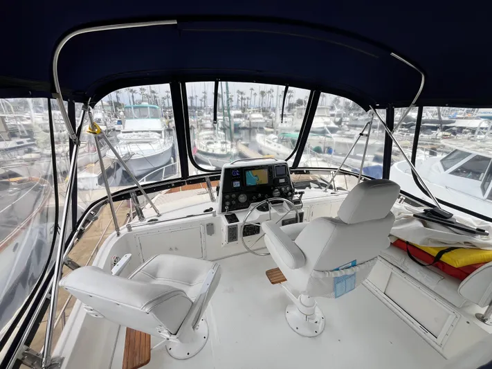 Journey Yacht Photos Pics Cockpit view of 1999 Ocean Alexander Sundeck 460 yacht with marina background.