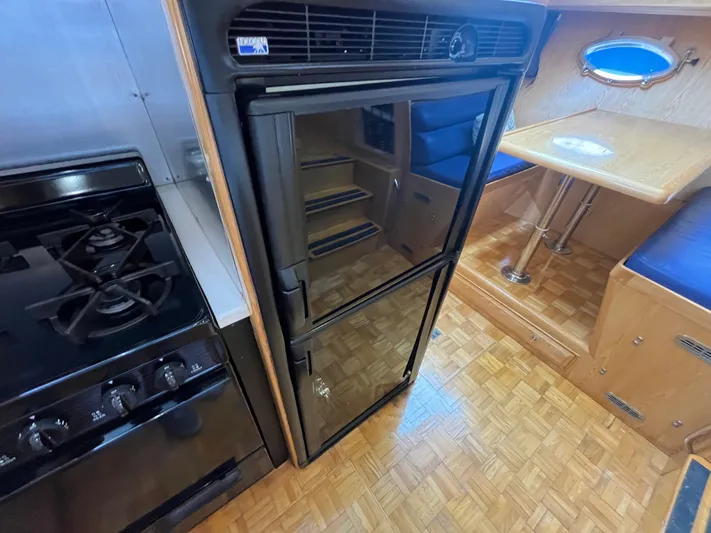 Journey Yacht Photos Pics Interior of 1999 Ocean Alexander Sundeck 460, featuring kitchen and dining area.