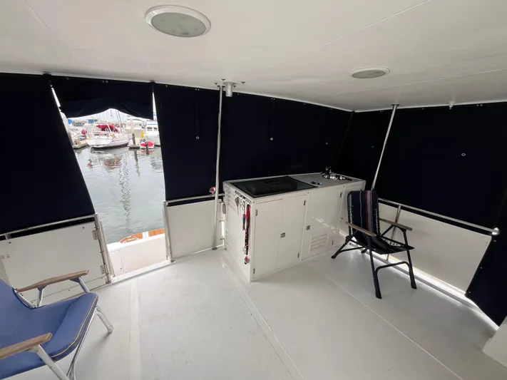 Journey Yacht Photos Pics 1999 Ocean Alexander Sundeck 460 interior with seating and kitchenette, docked at marina.