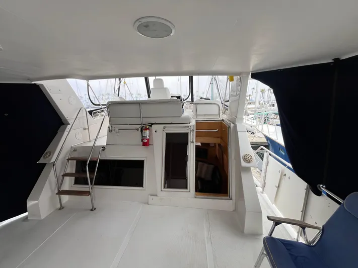 Journey Yacht Photos Pics 1999 Ocean Alexander Sundeck 460 yacht interior with seating and stairs, featuring a modern design.