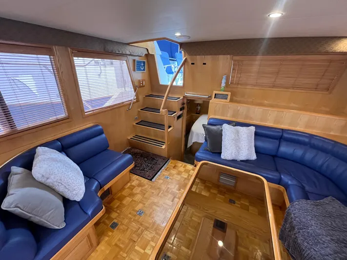 Journey Yacht Photos Pics Luxurious interior of 1999 Ocean Alexander Sundeck 460 yacht with blue leather seating.