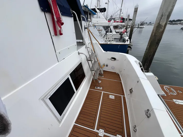 Journey Yacht Photos Pics 1999 Ocean Alexander Sundeck 460 yacht with teak deck, docked at marina.