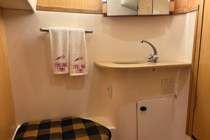  Yacht Photos Pics Bathroom interior of 1999 Tiara Yachts 4000 Express with sink and decorative towels.