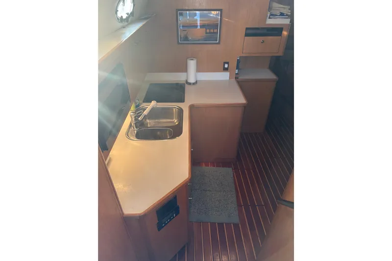  Yacht Photos Pics 1999 Tiara Yachts 4000 Express interior kitchen with wooden cabinetry and modern amenities.