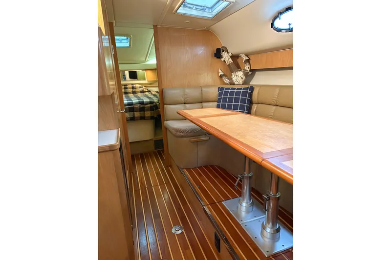  Yacht Photos Pics Interior of 1999 Tiara Yachts 4000 Express with wood flooring and cozy seating area.