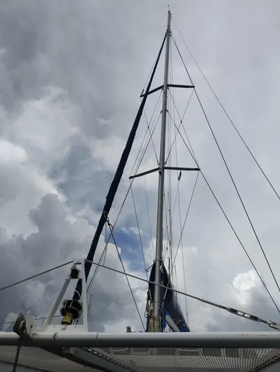  Yacht Photos Pics Mast of 2004 Lagoon 570 sailboat against cloudy sky.