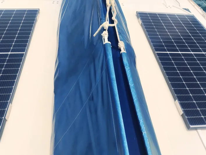  Yacht Photos Pics 2004 Lagoon 570 yacht with solar panels and blue sail cover.