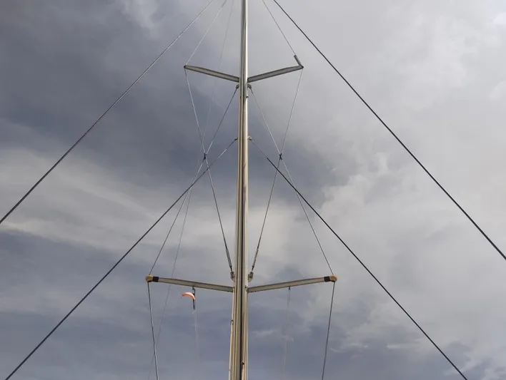  Yacht Photos Pics Mast of 2004 Lagoon 570 sailboat against a cloudy sky.