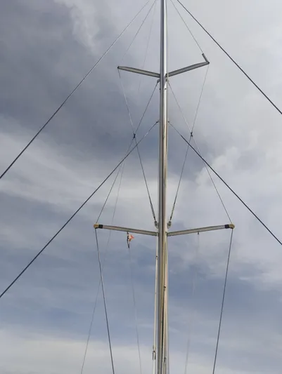  Yacht Photos Pics Mast of 2004 Lagoon 570 sailboat against cloudy sky.