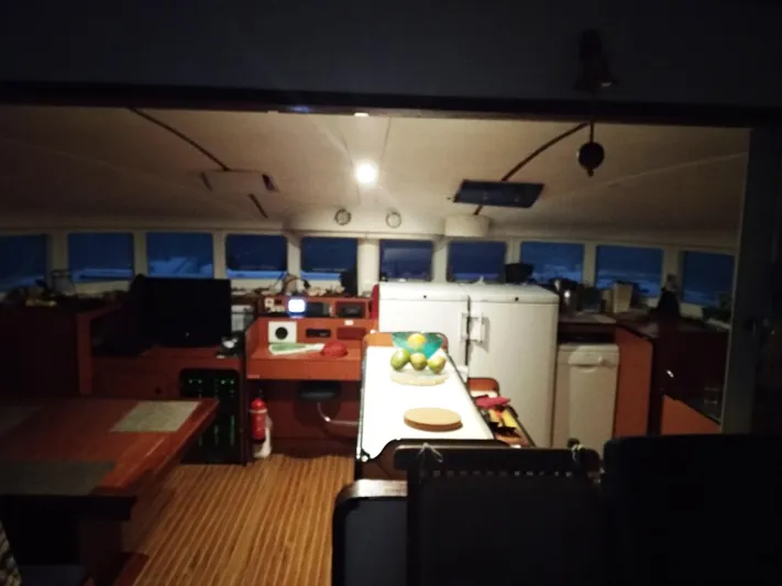  Yacht Photos Pics Interior of 2004 Lagoon 570 yacht with kitchen and dining area, featuring modern appliances.