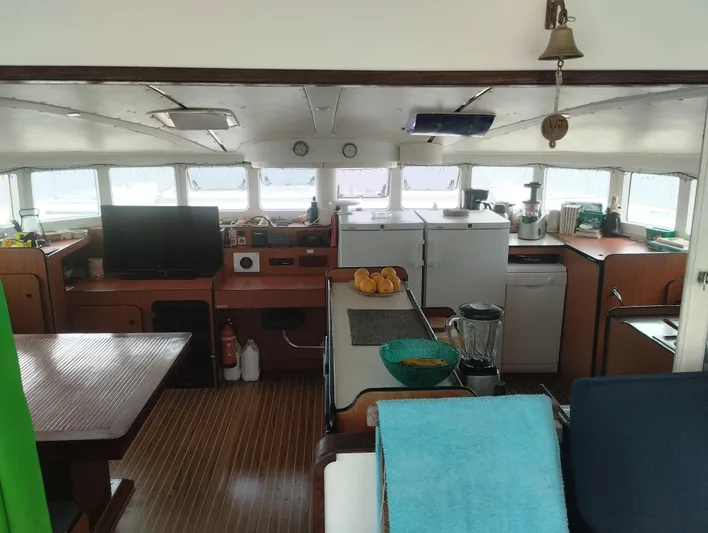  Yacht Photos Pics Interior of 2004 Lagoon 570 yacht with kitchen and dining area.