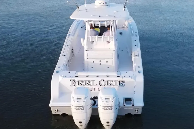  Yacht Photos Pics 2022 Sportsman Open 322 Center Console boat on water, rear view with twin engines.