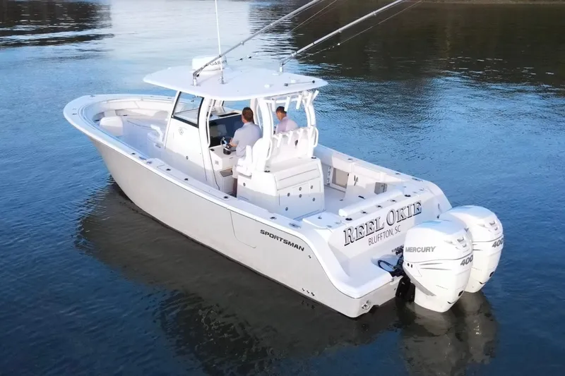  Yacht Photos Pics 2022 Sportsman Open 322 Center Console boat on calm water, featuring dual Mercury engines.