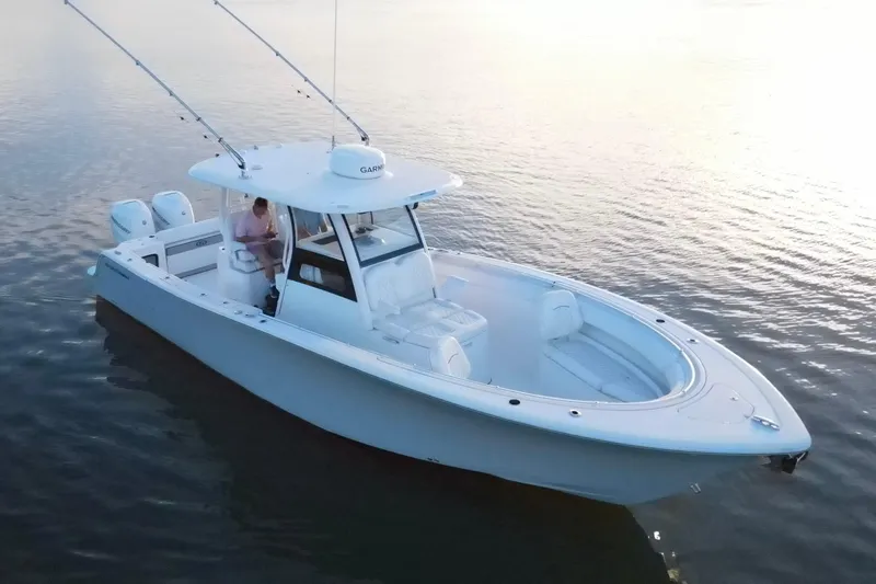  Yacht Photos Pics 2022 Sportsman Open 322 Center Console boat on calm water, featuring dual engines.