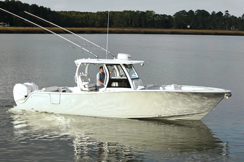  Yacht Photos Pics 2022 Sportsman Open 322 Center Console boat cruising on calm water.