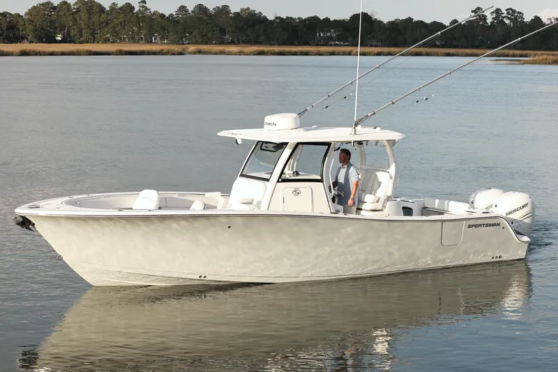  Yacht Photos Pics 2022 Sportsman Open 322 Center Console boat on calm water, featuring fishing rods.