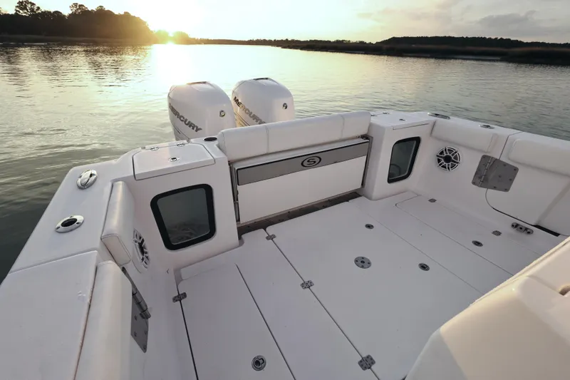  Yacht Photos Pics 2022 Sportsman Open 322 Center Console boat at sunset on calm water.