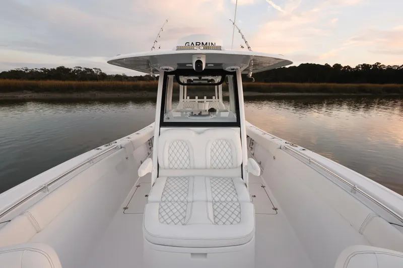  Yacht Photos Pics 2022 Sportsman Open 322 Center Console boat on calm water at sunset.