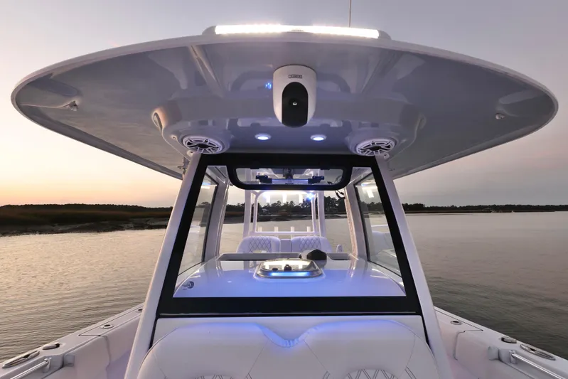  Yacht Photos Pics 2022 Sportsman Open 322 Center Console boat at sunset on calm water.