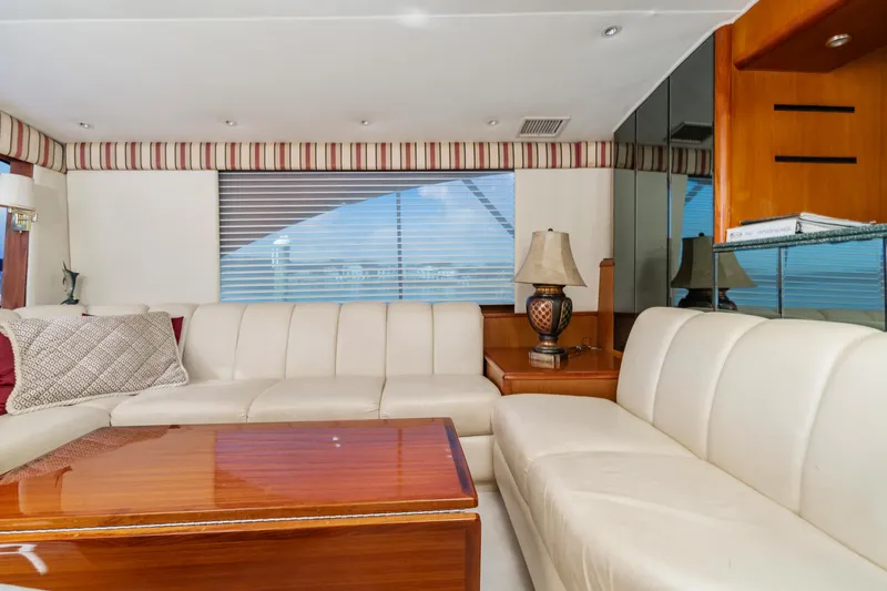 Tunar Yacht Photos Pics Luxurious interior of 1999 Ocean Yachts 56 Super Sport with white seating and wooden table.