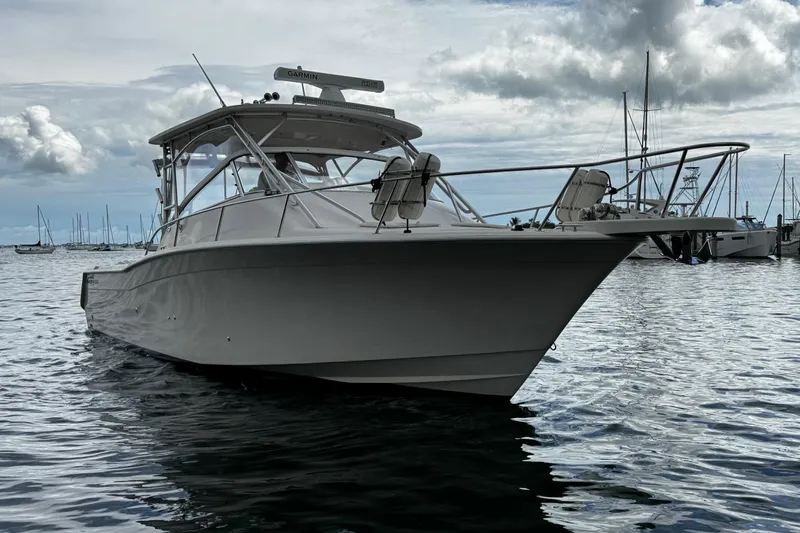  Yacht Photos Pics 2001 Grady-White Express 330 boat on calm water, cloudy sky background.