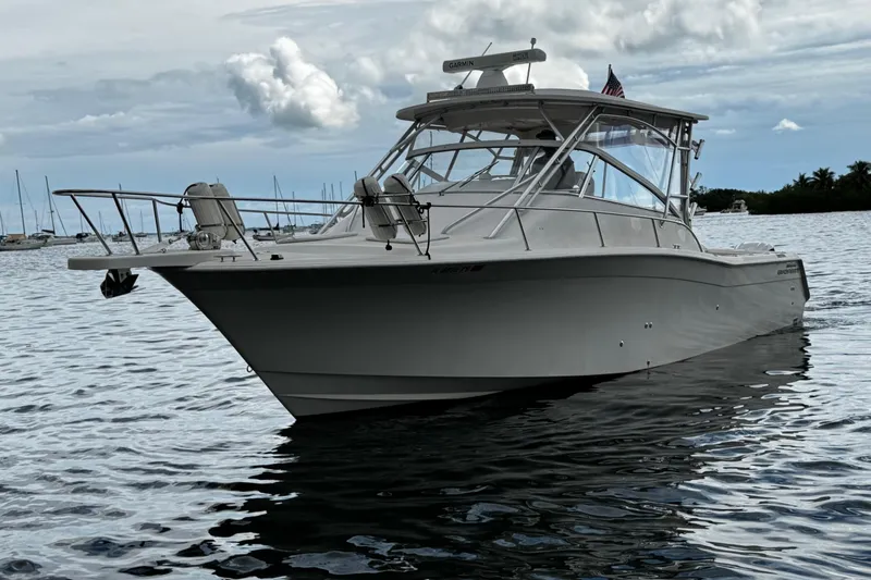  Yacht Photos Pics 2001 Grady-White Express 330 boat on calm water, cloudy sky background.