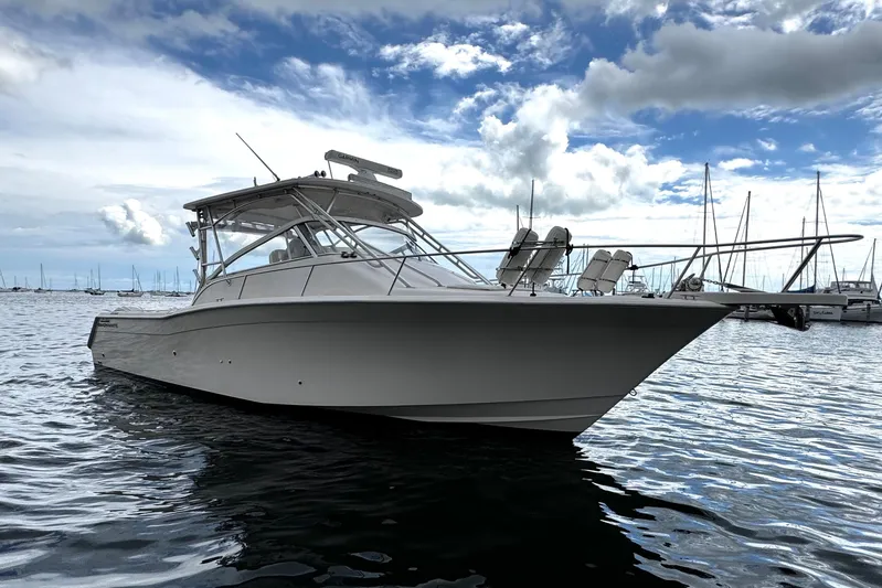  Yacht Photos Pics 2001 Grady-White Express 330 boat on calm water under cloudy sky.